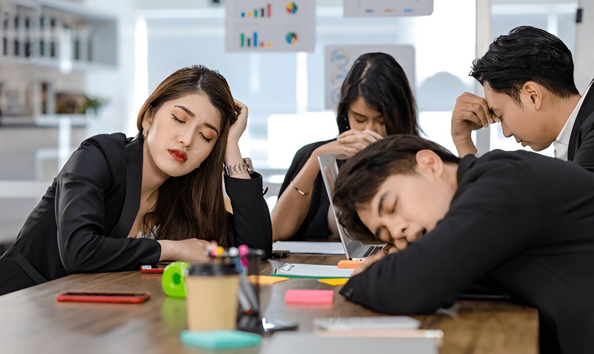 tired exhausted businesspeople sleeping after working late overtime