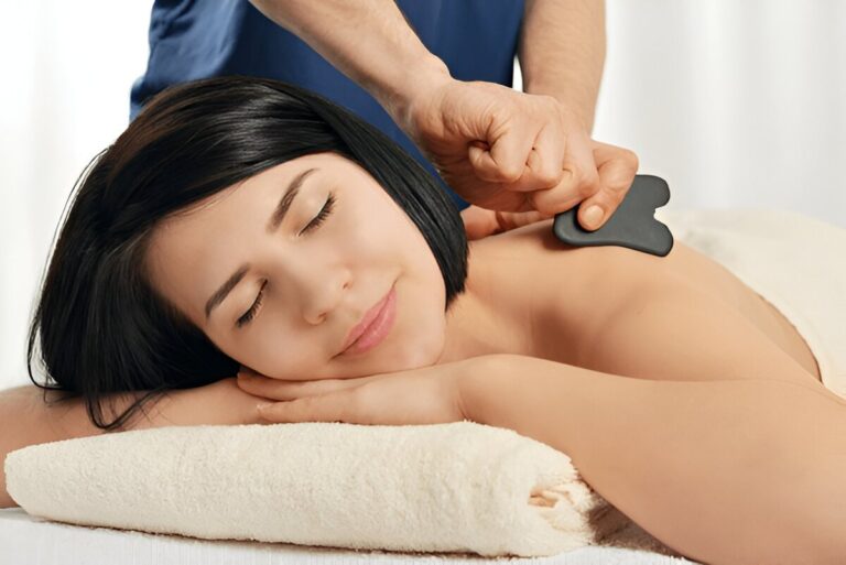 Woman receiving gua sha acupuncture treatment on back