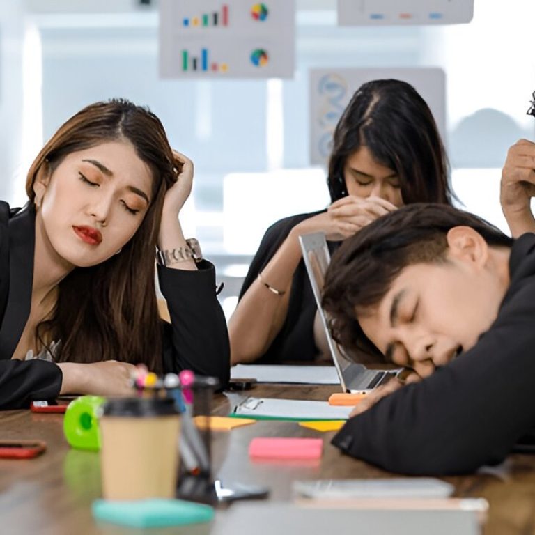 tired exhausted businesspeople sleeping after working late overtime